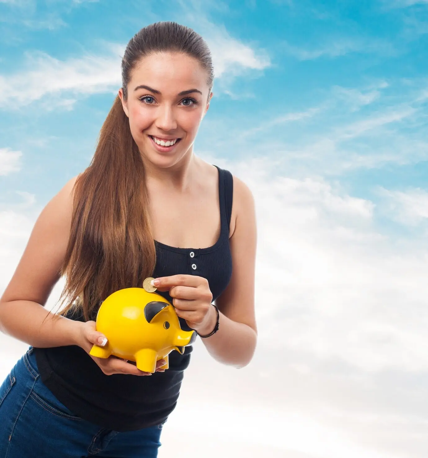 Smiling woman tossing a coin into a pig-shaped piggy bank